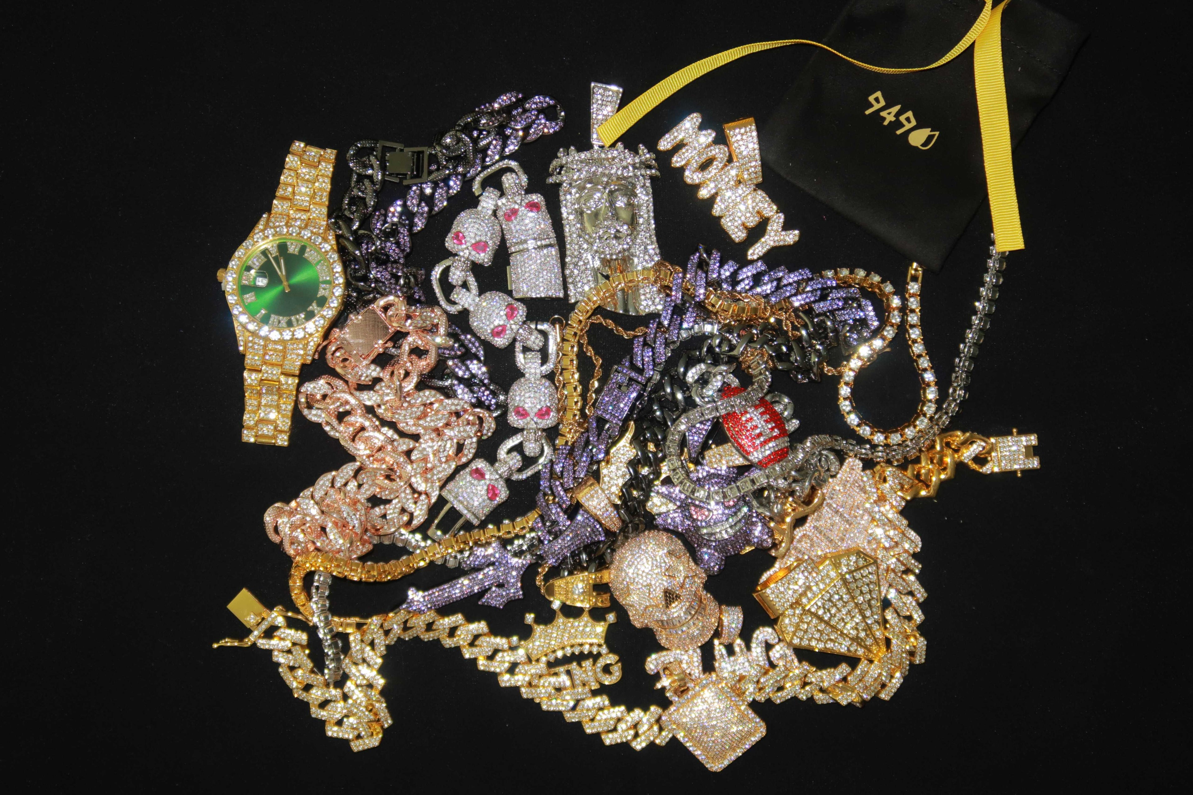 Collection of various jewelry items including watches and necklaces on a black background